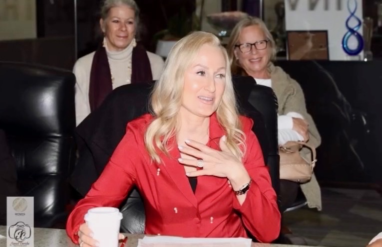 Agent Karrie Decker in a red blazer at an industry event